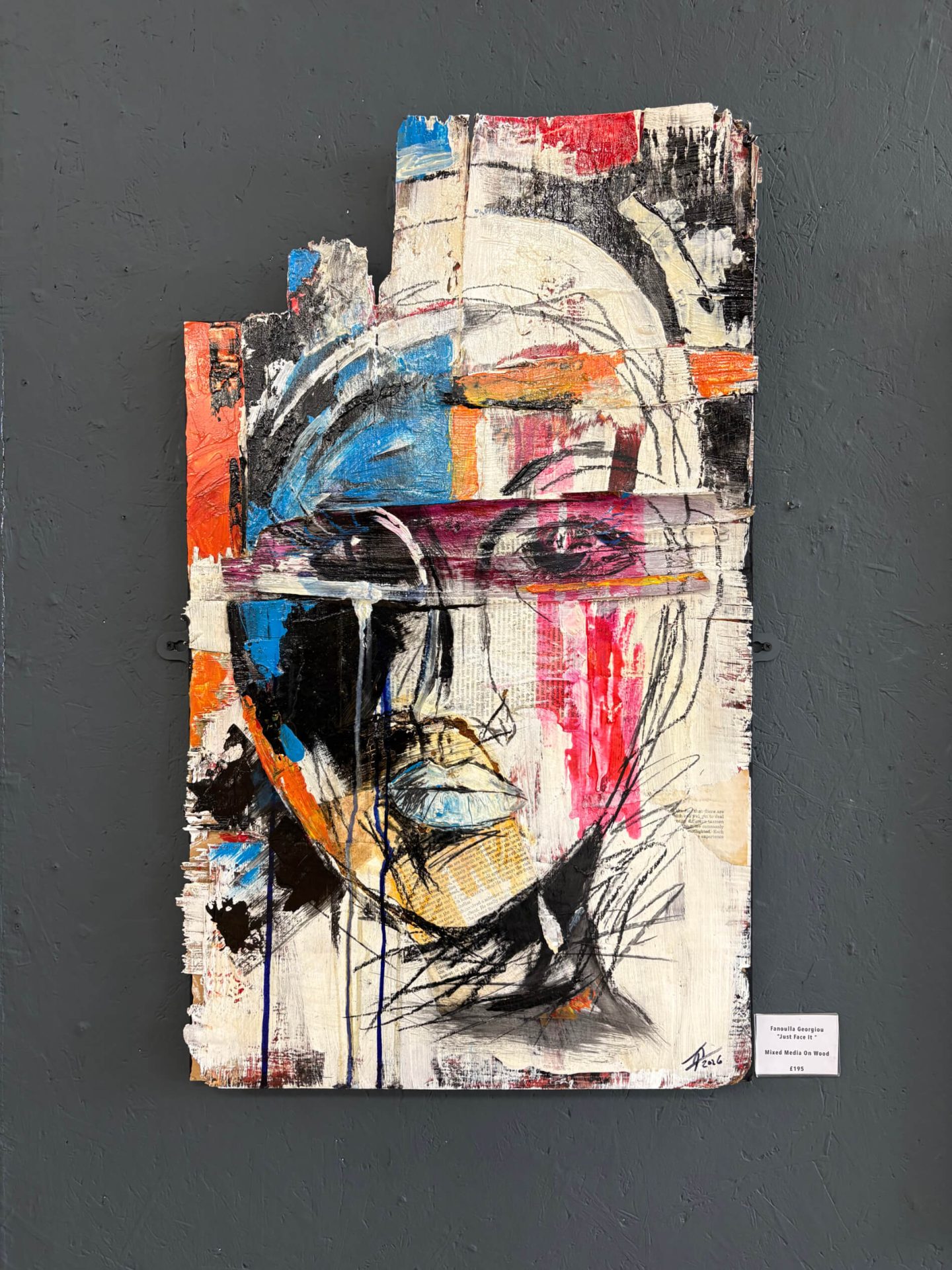A large-scale, highly textured contemporary portrait characterized by abstract expressionism. The piece features fragmented planes of vibrant colour (including blue, red, and white) layered over raw canvas, capturing a dynamic and emotional intensity within the subject's features.